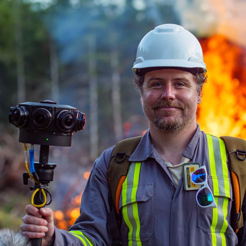 360 video camera operator filming controlled burn with Insta360 Pro camera and safety gear