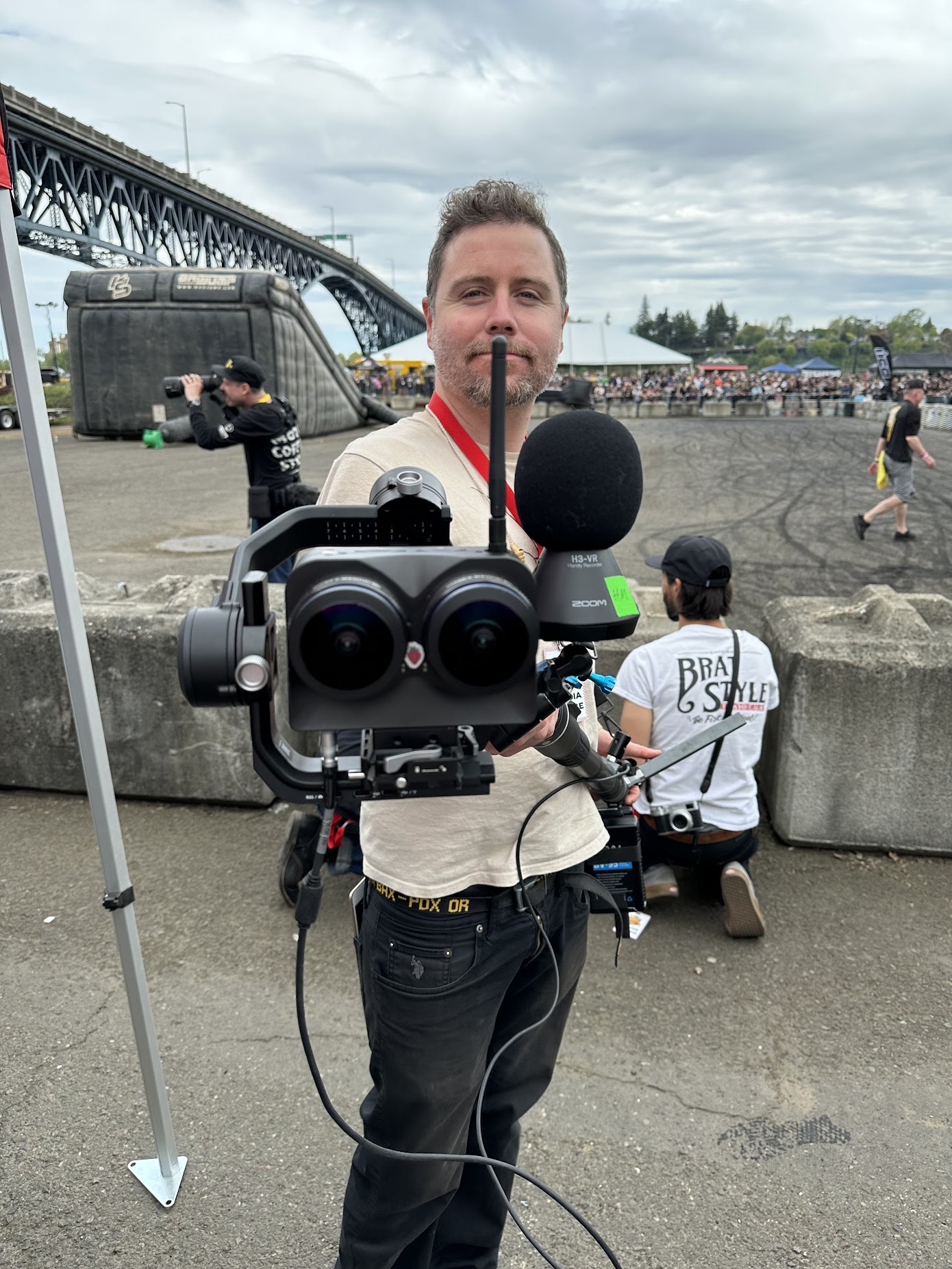 Professional VR 180 camera operator with Canon RF 5.2mm dual fisheye lens at outdoor live event